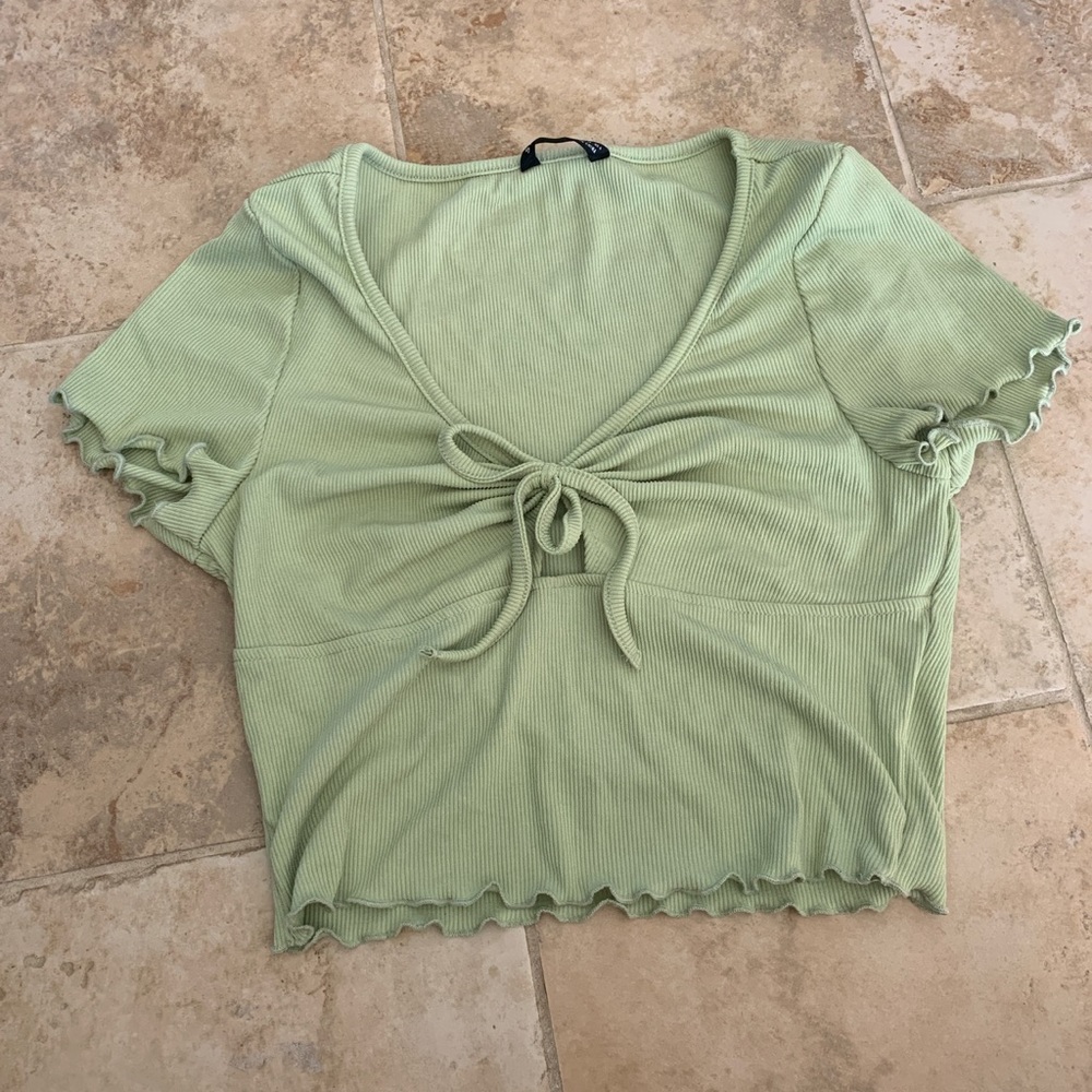Pale green cropped frilly tie top